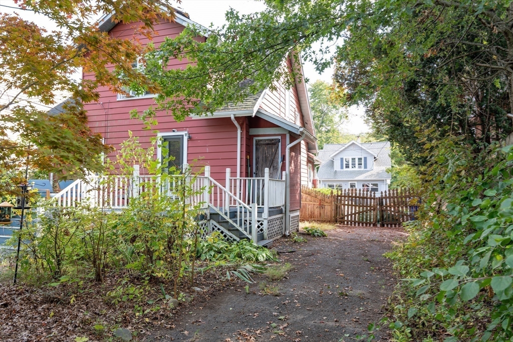 60 Blake Street Springfield, MA 01108 - Photo 25 of 30 a view of a house with wooden fence and a tree