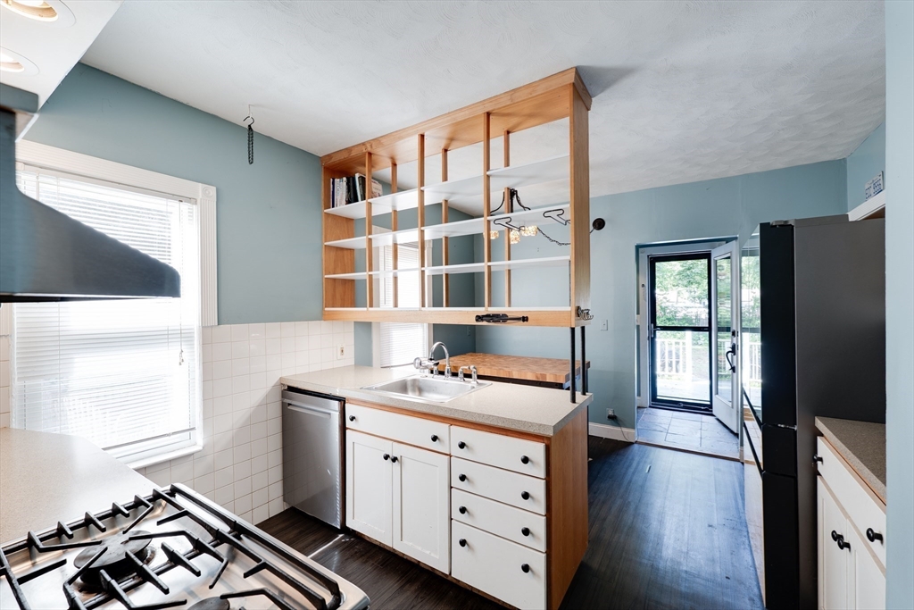 60 Blake Street Springfield, MA 01108 - Photo 7 of 30 a kitchen with a stove window and cabinets