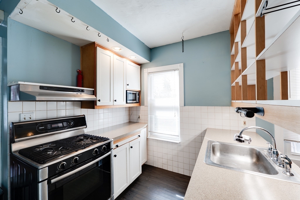 60 Blake Street Springfield, MA 01108 - Photo 8 of 30 a kitchen that has a sink and a stove