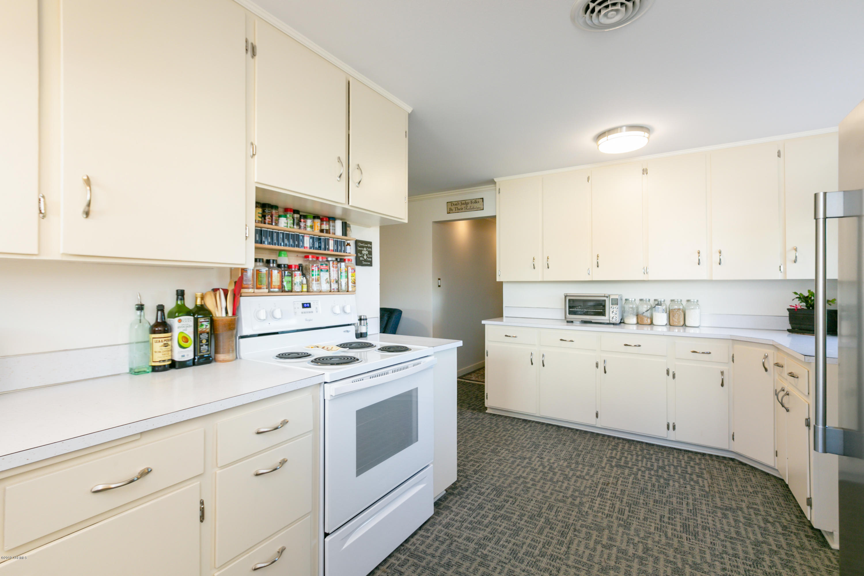 250 Rudd Road Tieton, WA 98947 - Photo 13 of 29 a kitchen with cabinets stainless steel appliances a stove a sink and white cabinets
