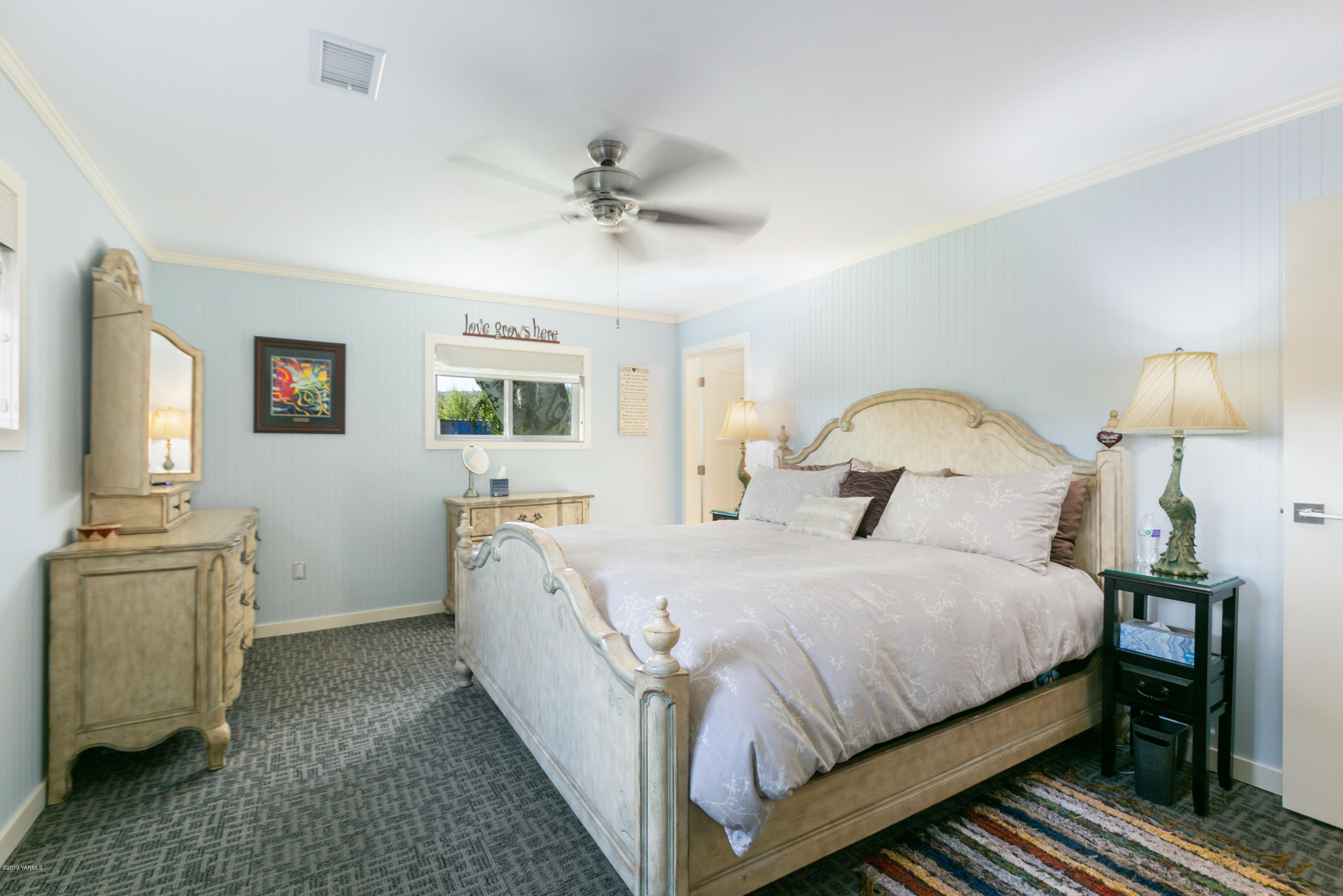 250 Rudd Road Tieton, WA 98947 - Photo 10 of 29 a bedroom with a bed and a chandelier