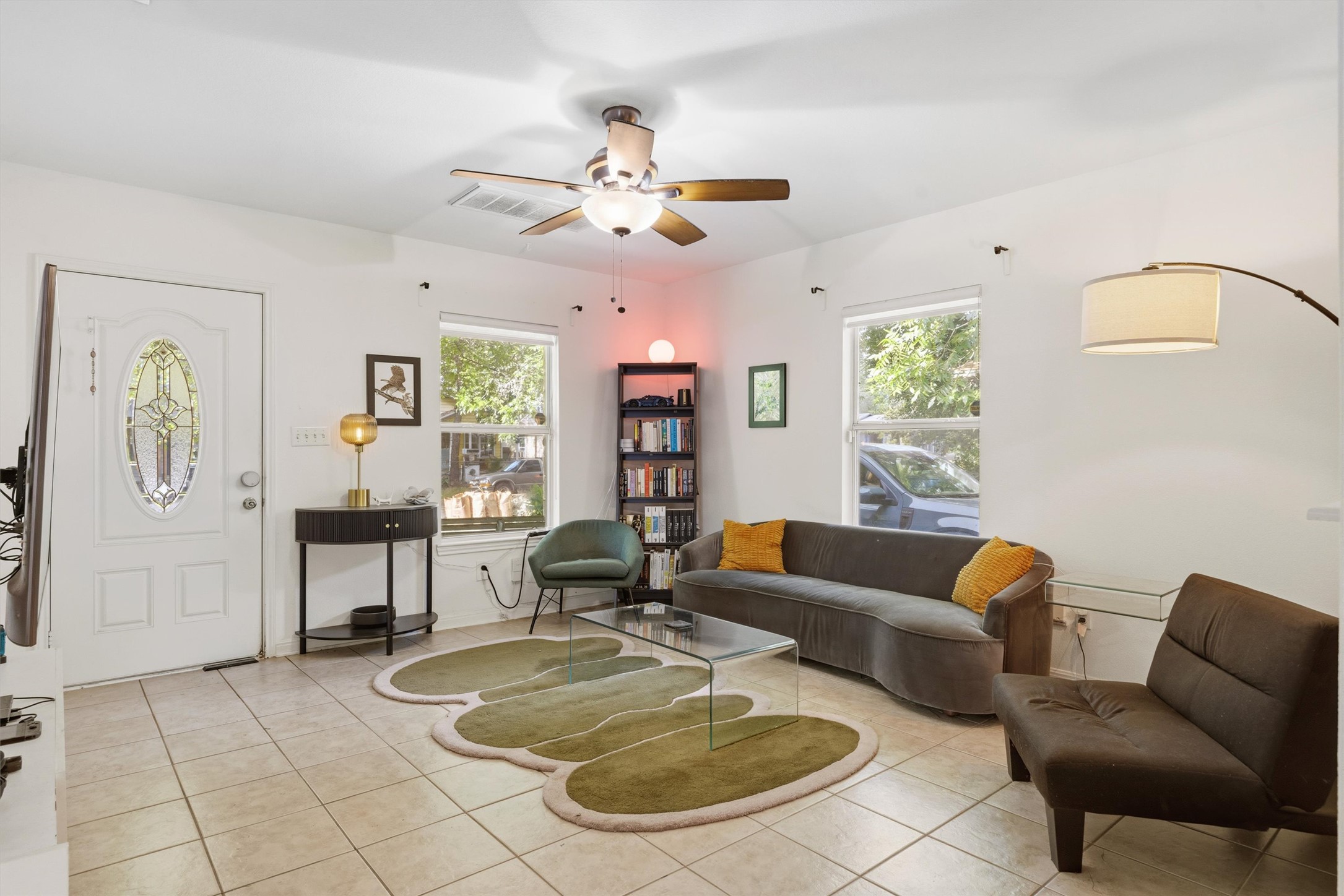 3015 Castro Street Austin, TX 78702 - Photo 7 of 40 Natural light floods this inviting living space with tiled flooring and ample room for relaxation.