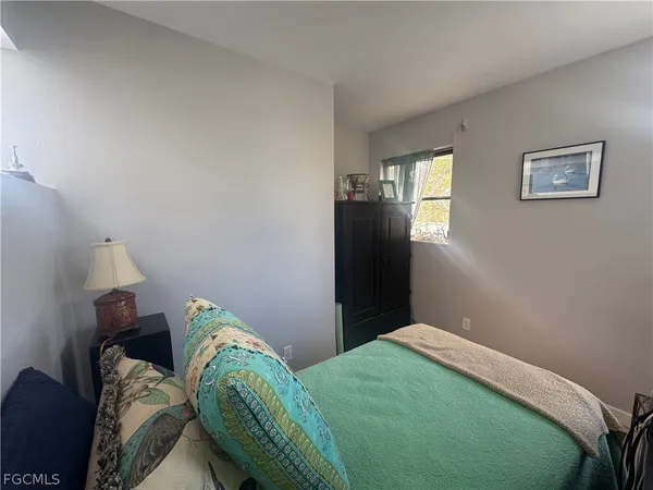 a bedroom with a bed and hallway