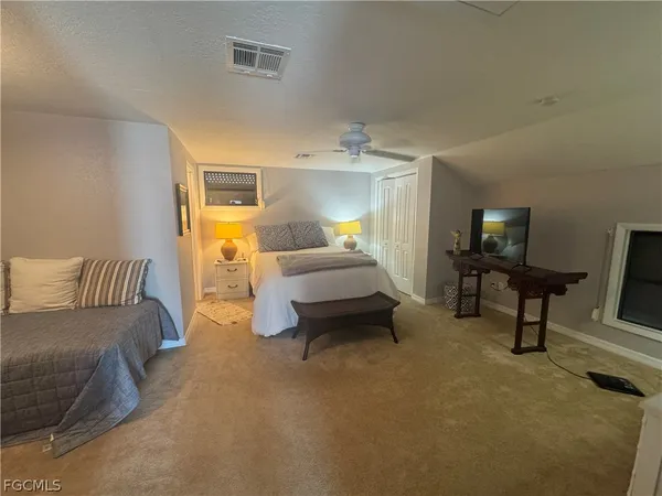 a bedroom with a bed and a tv