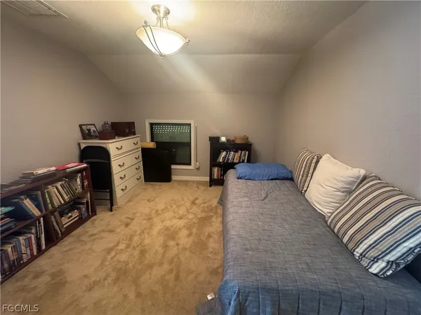 a bedroom with bed and wooden floor