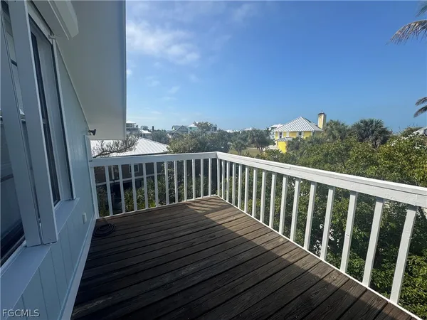 a balcony with wooden floor and fence