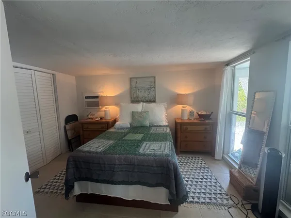 a bedroom with furniture and a lamp