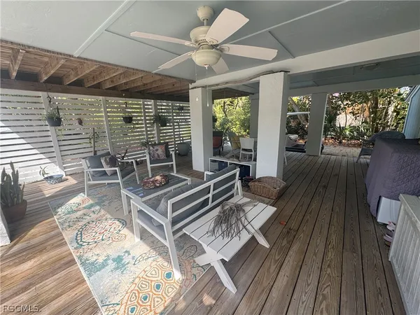 a living room with wooden floor furniture and a large window