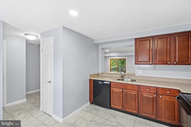 a kitchen with a sink cabinets and window