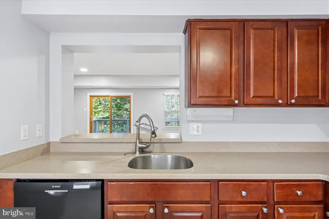 a kitchen with a sink cabinets and a window