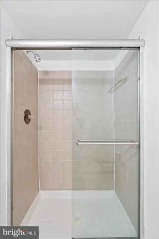 a bathroom with a glass shower door