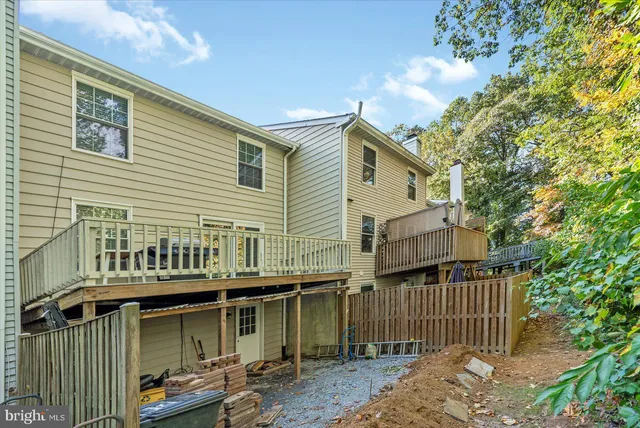a view of a house with wooden deck and furniture