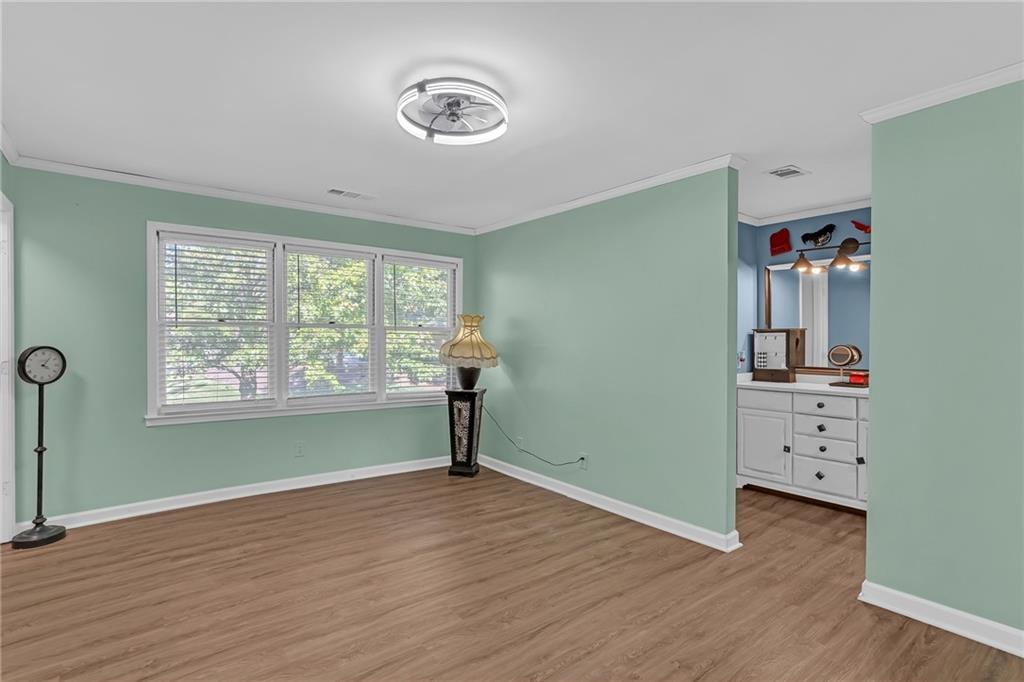 6315 Windsor Trace Drive Peachtree Corners, GA 30092 - Photo 3 of 26 an empty room with a window and wooden floor