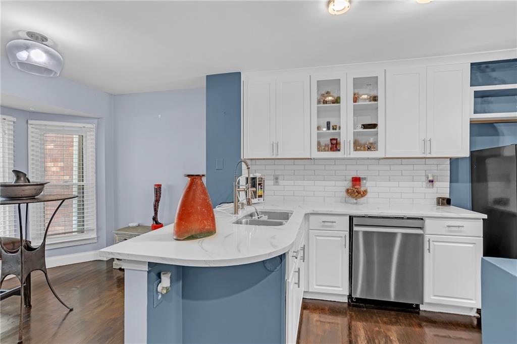 6315 Windsor Trace Drive Peachtree Corners, GA 30092 - Photo 9 of 26 a kitchen with a sink a stove and white cabinets