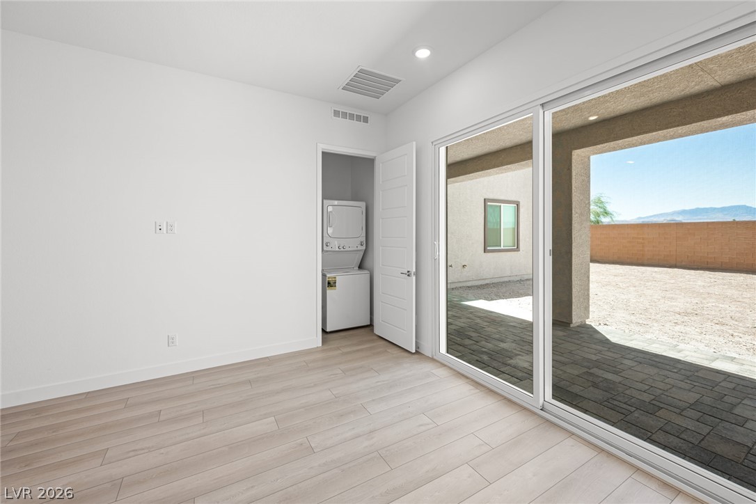 9983 Decano Ridge Street Las Vegas, NV 89141 - Photo 6 of 39 A well-lit room opens to a private patio, offering a seamless indoor-outdoor transition.
