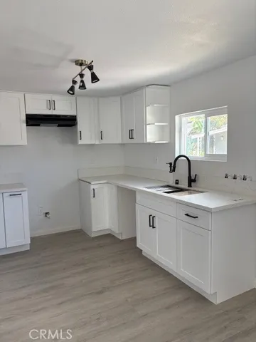 a kitchen with a sink cabinets and window