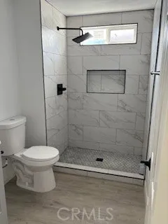 a bathroom with a toilet and a shower