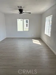 an empty room with wooden floor and door