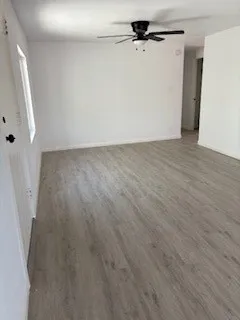 a view of a room with wooden floor