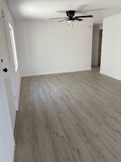 1680 South Tartar Lane, Unit 27 Compton, CA 90221 - Photo 10 of 12 an empty room with wooden floor and door