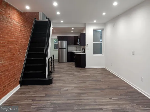 a view of kitchen with refrigerator and microwave
