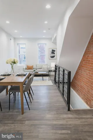 a view of dining room and livingroom with furniture wooden floor and a rug