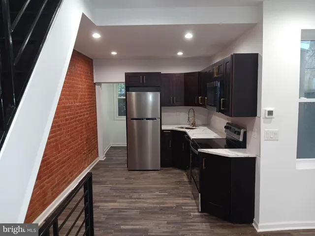a kitchen with refrigerator and cabinets