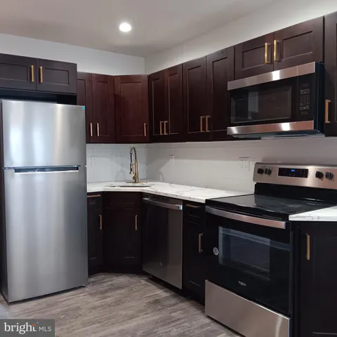 a kitchen with a refrigerator and a stove