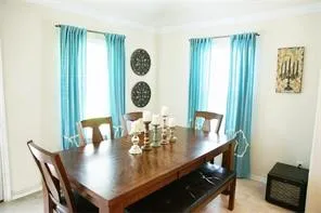 a view of a dining room with furniture and chandelier