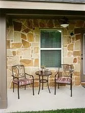 a view of a chairs and table in the back yard of the house