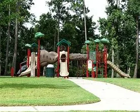 a view of a park with swings and slides