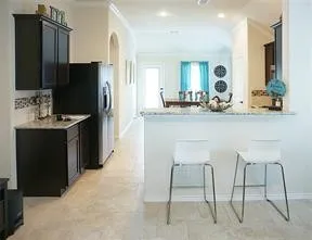 a kitchen with kitchen island a counter top space cabinets and stainless steel appliances