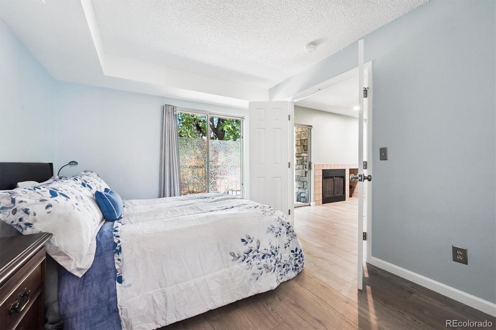 2575 South Syracuse Way, Unit L103 Denver, CO 80231 - Photo 14 of 21 a bedroom with a bed and a table in it