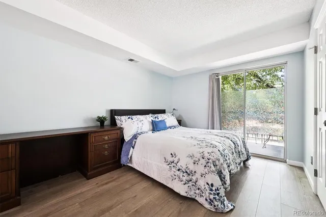 a bedroom with a bed and a night stand