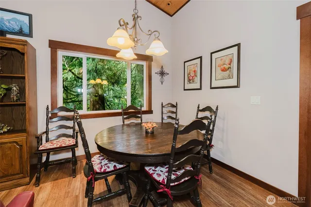 a living room with furniture a flat screen tv and floor to ceiling window