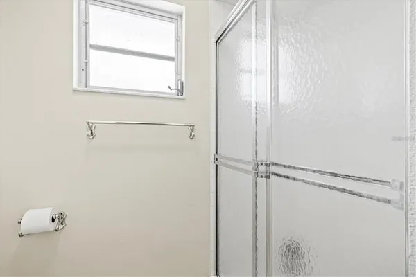 a bathroom with a glass shower door