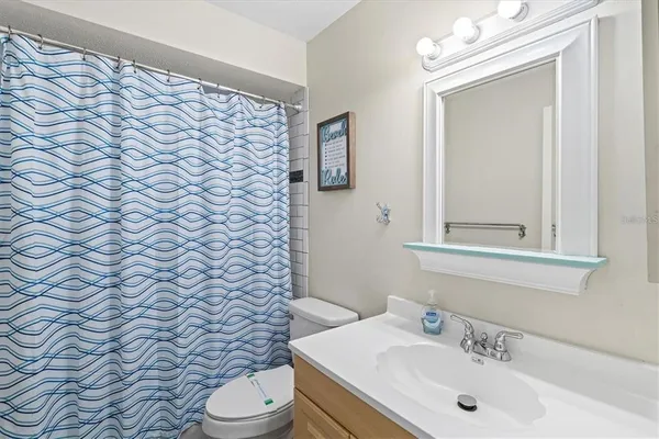 a bathroom with a sink a toilet and mirror