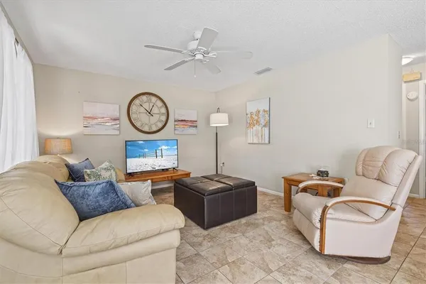 a living room with furniture a clock and a lamp