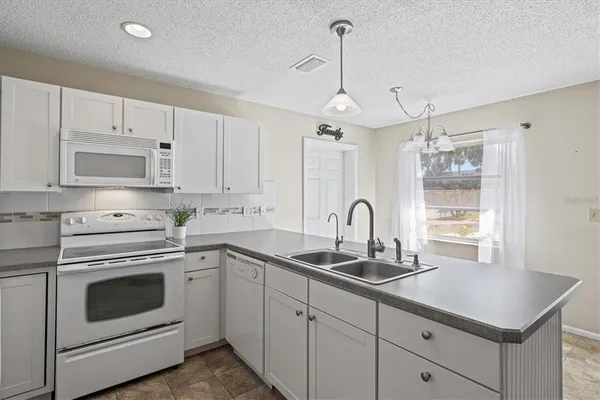 a kitchen with appliances cabinets and a sink