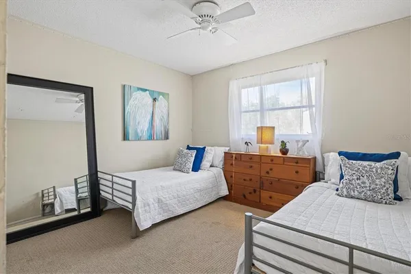 a bedroom with two beds and a window