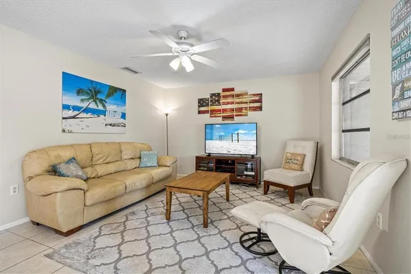 a living room with furniture and a painting on the wall