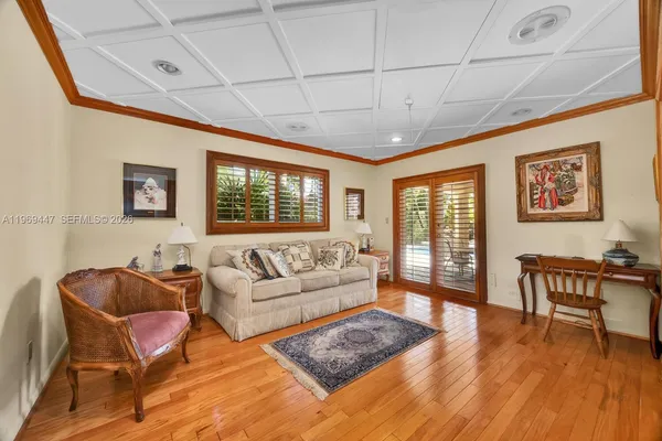 a living room with furniture a wooden floor and a window