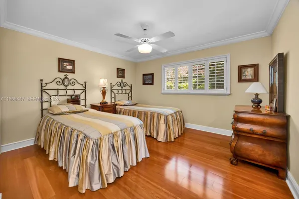 a bedroom with furniture and wooden floor