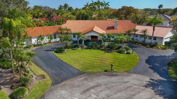 an aerial view of a house with outdoor space patio and lake view