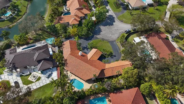 an aerial view of a house with a yard and outdoor seating