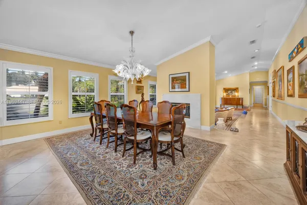 a view of a dining room with furniture a chandelier and wooden floor