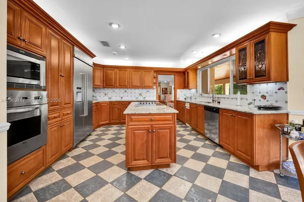 a kitchen with stainless steel appliances granite countertop a sink and cabinets