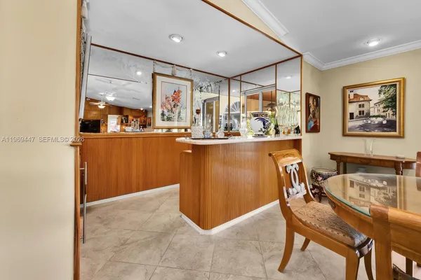 a room with table chairs and wooden floor