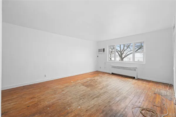 a view of an empty room and wooden floor