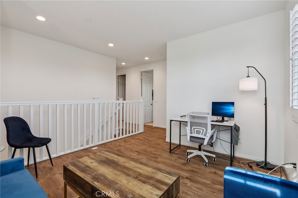 7656 Channel View Street Chino, CA 91708 - Photo 15 of 40 a workspace with furniture and wooden floor